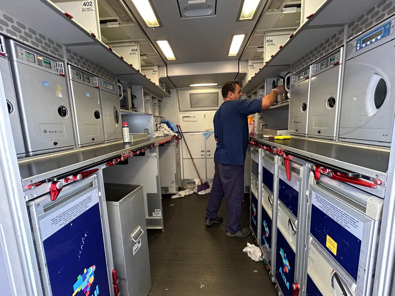 Technician sanitizing the aircraft galley