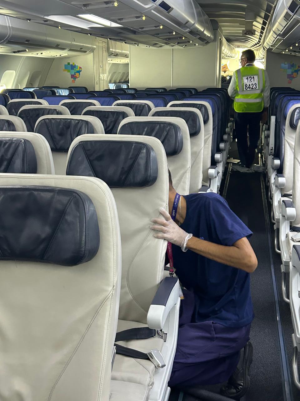 Technician sanitizing a seat back